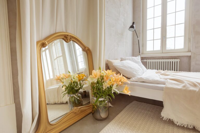 Interior of elegant bedroom at home Bouquet of lilies flowers